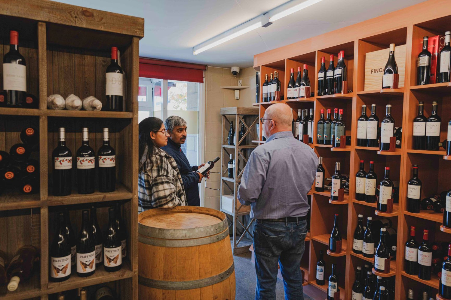 Guy at Elvino recommending wine to customers who had visited the store