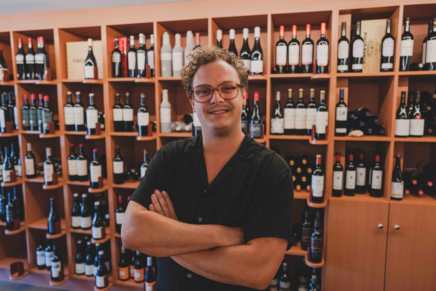 Tom Vanhooren posing for a portrait in the Elvino store