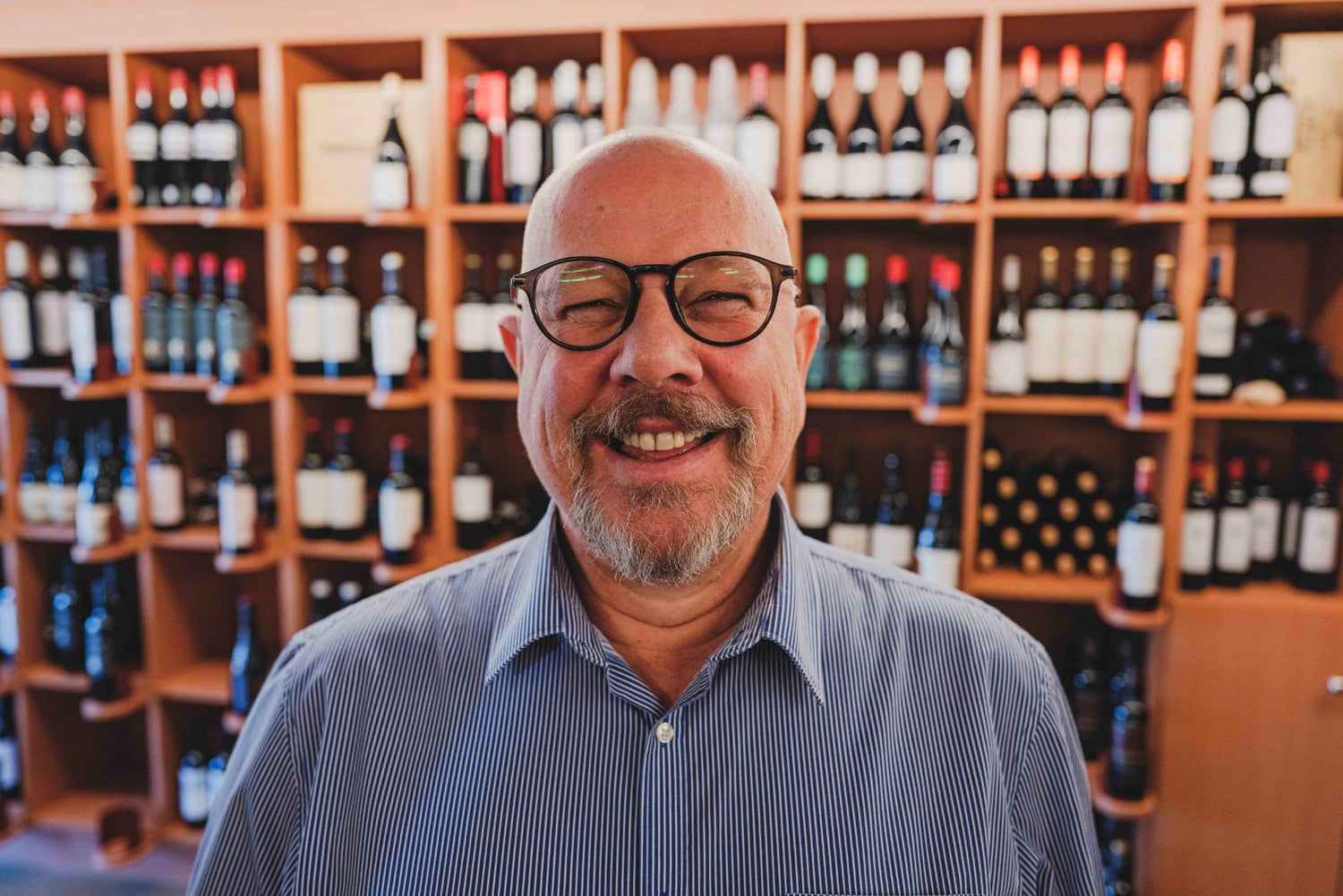 Guy Dresselaers posing for a portrait in his Elvino store